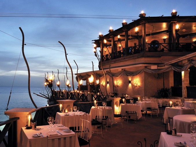 The Cliff Restaurant in Barbados glowing gently in the warm Bajan dusk