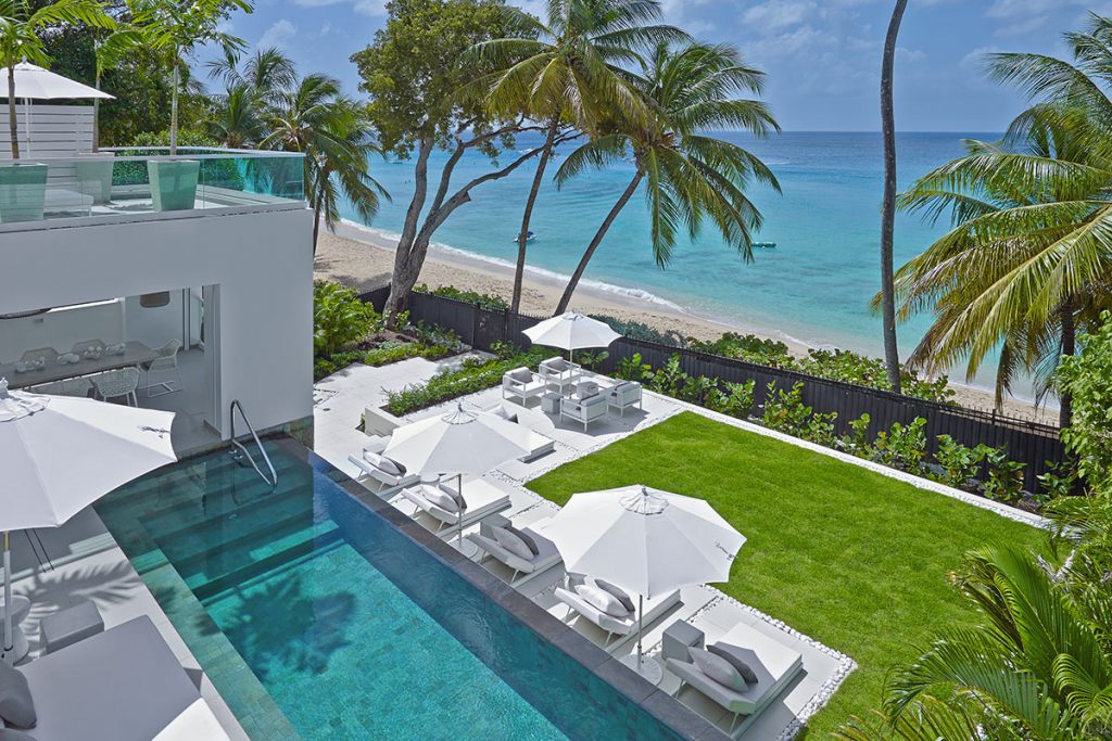 The View of the pool and then the beach from the second floor of Footprints. The villa has clean cut white edges and glitters prettily in the Caribbean sun.