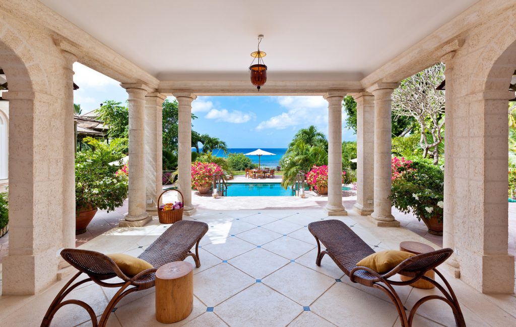 Brown rattan style recliners under the shaded marble patio at Gardenia provides cool and comfortable shade from the midday sun.