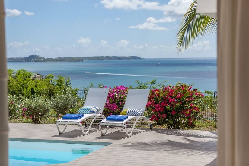 Pool, sun longeres and coastline at Sea Dream