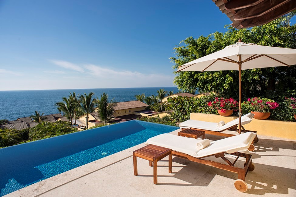 Villa at the Four Seasons in Punta Mita Warm tropical sun beats down on sun-loungers by a pool that glitters with deep ultramarine waters