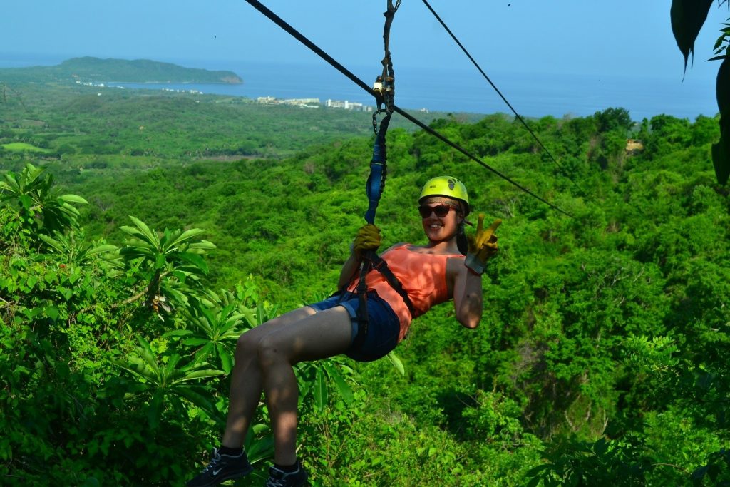 Emma casually zip-lines at hair-raising height across the jungle at Punta Mita
