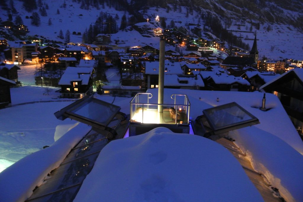 Backstage Chalet A loan bather sits in the warm, bubbly comfort of the rooftop Jacuzzi of the Backstage Chalet in Zermatt