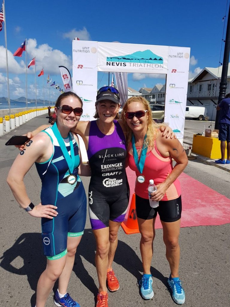 The first three of the 2017 Nevis triathlon pose at the finish line