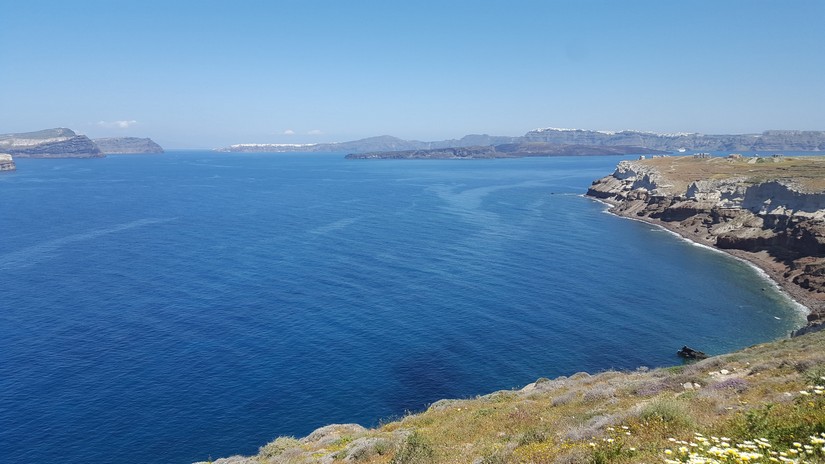 The view of the sea encompassed by a volcanic caldera as seen from the lighthouse at akrotiri in santorini, Greece