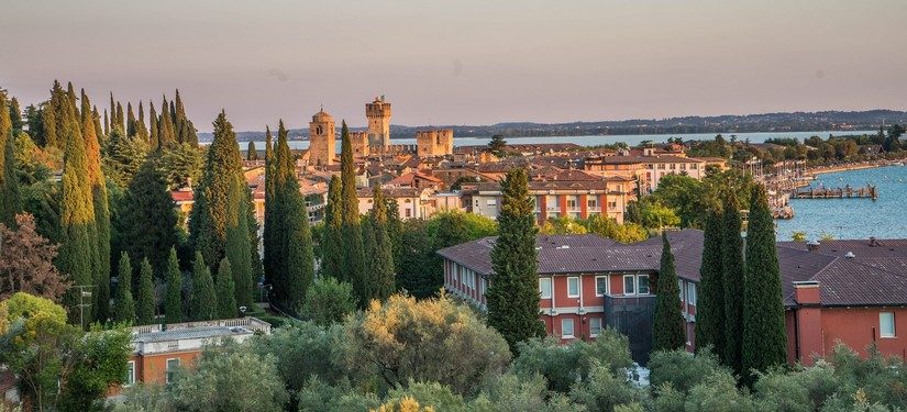 a beautiful sunset over a town on Lake Garda, Amalfi Coast