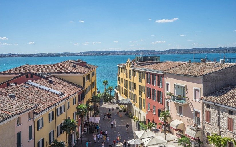 A colouful vibrant piazza leading down to Lake Garda