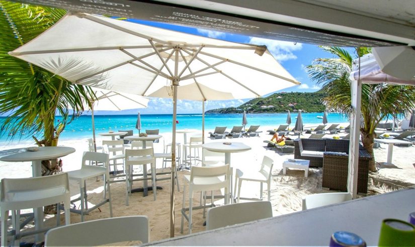 Parasols and palm trees provide cooling shade for diners at this restaurant on the beach. Not far from the dining area the Caribbean Seas glitters in the sunlight in exactly the same way that coal doesn't. Considered to be one of the best places to in eat in St Barts La Plage is a very popular spot for visitors and locals alike.