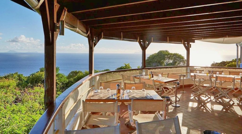 The dining are at Santa Fe is a curved balcony that has a frankly epic view of the vast blue horizon over a fringe of thick green forest. The floor is paved with smooth terracotta tiles and the restaurant is shaded by a ceiling with rich, dark open joists. It's lovely.