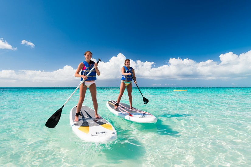 Paddle Boarding on the crystallized waters of Grace Bay, one of the Best Caribbean beaches Paddle Boarding on Grace Bay Beach - Clear turquoise waters with white powdery sands
