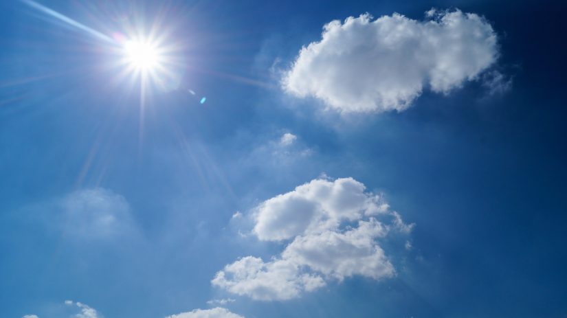 Wonderful blue sky, light fluffy clouds and brilliant sunshine