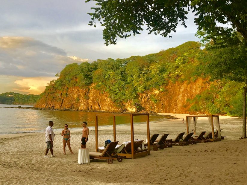 A picturesque beach in costa rica with sun loungers