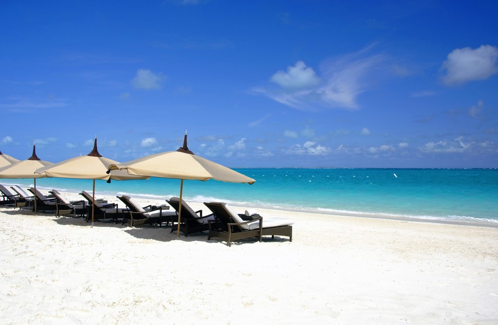 Endless shades of turquoise sea melts onto the sugar fine sandy beaches, here along the elegant Turks and Caicos resorts