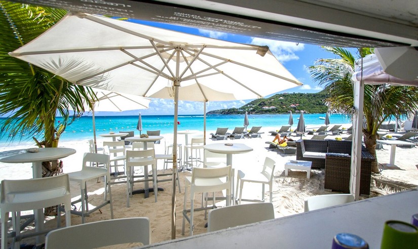 Pearl Beach Restaurant with its sun loungers high tables, high stools, and parasols looking out over the beach