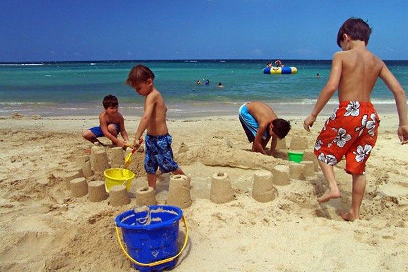 kids making sandcastles at jamaica resort