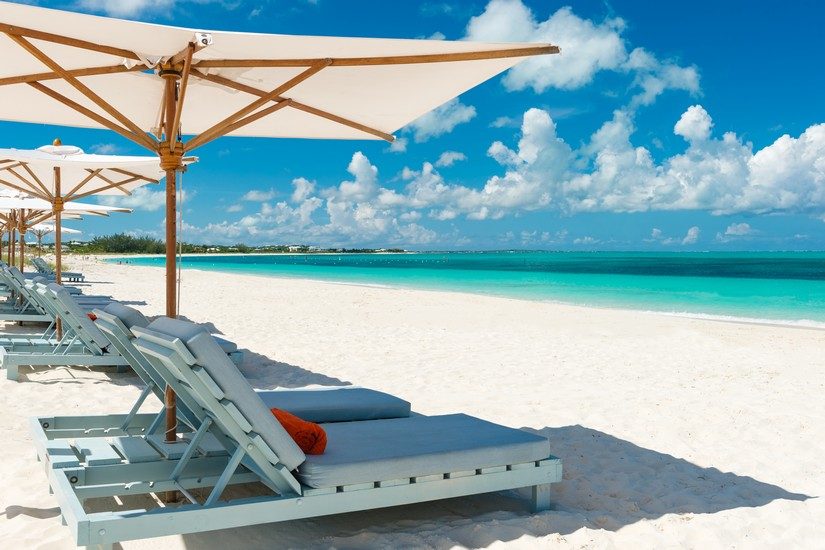 deck chairs on the beach at the beach house, a turks and caicos all inclusive honeymoon resort