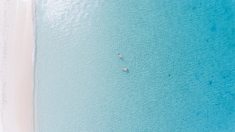 two girls swimming in a stunning beach in anguilla