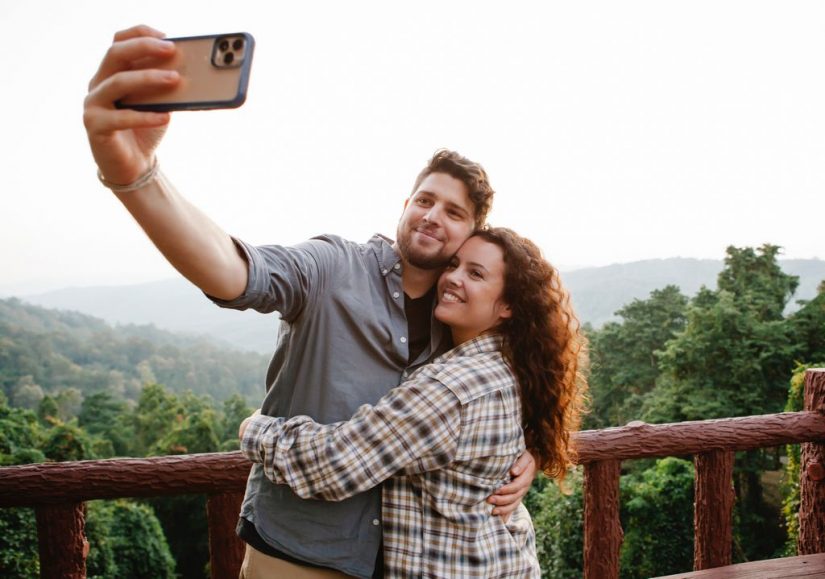 Costa Rica honeymoon couple take selfie in front of forest
