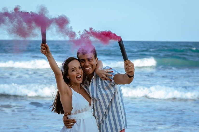 couple on the beach celebrating best babymoon destination