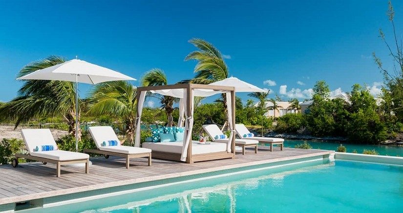 terrace with deck chairs and pool in this luxury providenciales villa