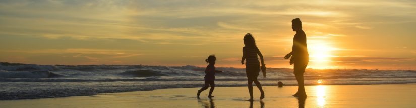 Family on the beach at sunset