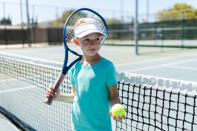 a child holding a tennis racket