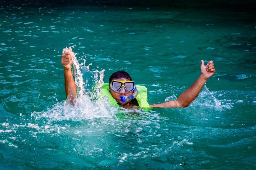 a kid snorkeling in Anguilla one of the best things to do in Anguilla