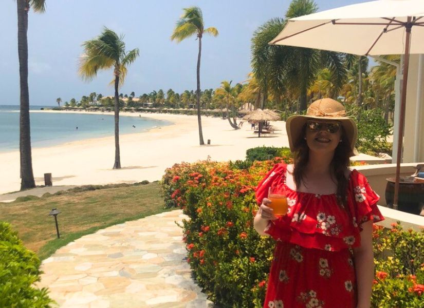 Linda enjoying a cocktail on arrival at Jumby Bay resort for her Antigua honeymoon