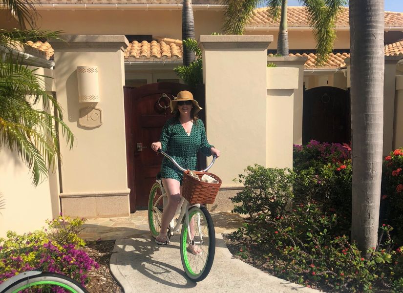 Linda from Exceptional villas on a bike at Jumby Bay one of the best resort for an Antigua honeymoon