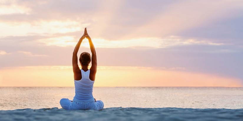 lady doing yoga on the beach
