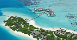 Aerial view of an over-water-villa resort in the Maldives