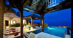 Dreamily lit pool area in the evening at a thai villa