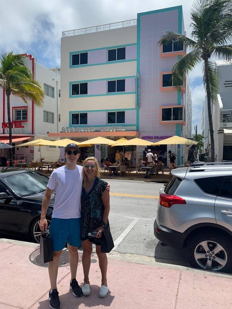 Art Deco building in the background with a couple standing in front of it