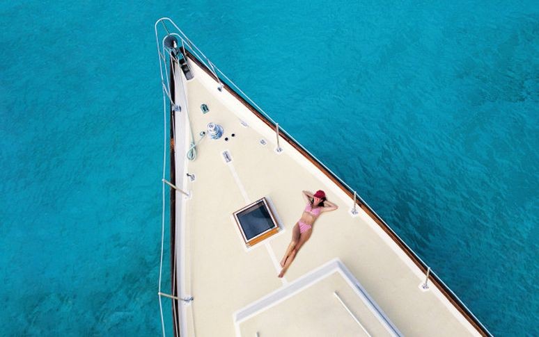 Lady sunbathing on a boat in port ferdinand