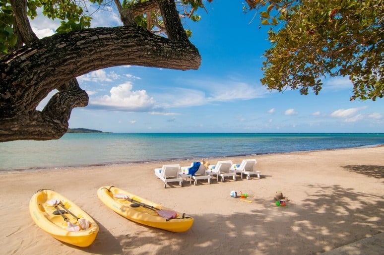 Sun loungers, sandcastles, and canoes at a beach at Montego Bay