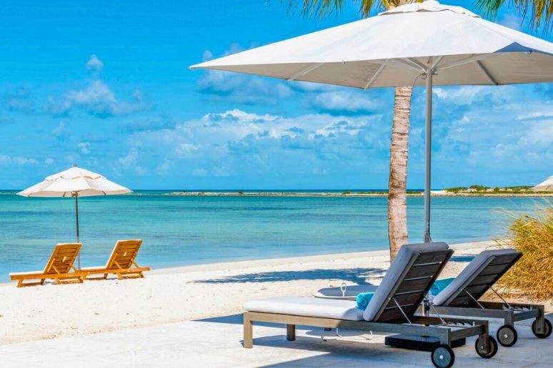 Two sun loungers on the beach at Ambergris Cay Turks and Caicos