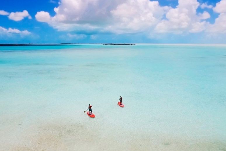 Two people paddle boarding at Sailrock resort 
