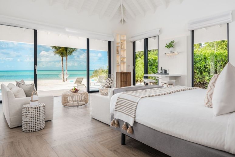 A bedroom and view at a suite in Ambergris Cay Turks and Caicos