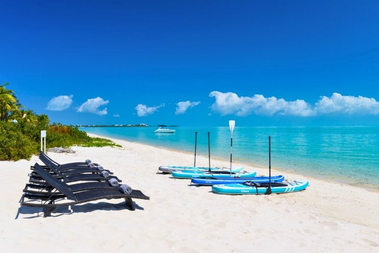 paddle boards on beach at long bay in turks and caicos 