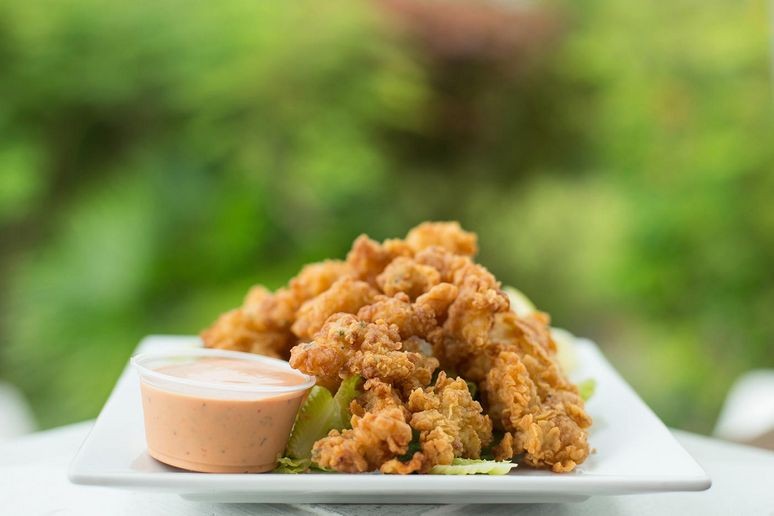 A bowl of delicious food at grace bay in turks and caicos.  Possibly some kind of deep fried seafood.