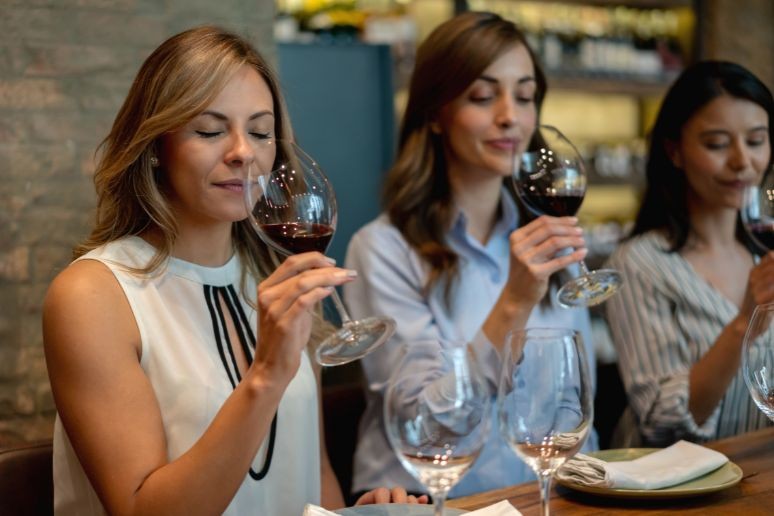 three ladies tasting wine in italy at a corporate retreat