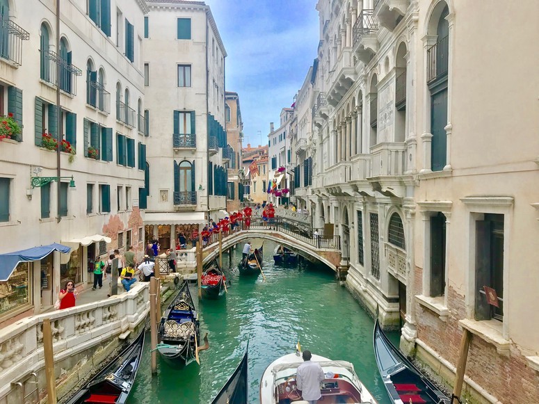 View of a street alongside a canal with Gondolas