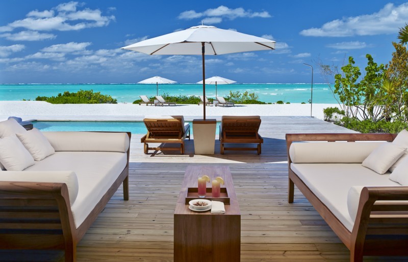 Sun Deck and loungers at Como Parrot Cay luxury resort in Turks and Caicos looking across lots of blue Caribbean Sea