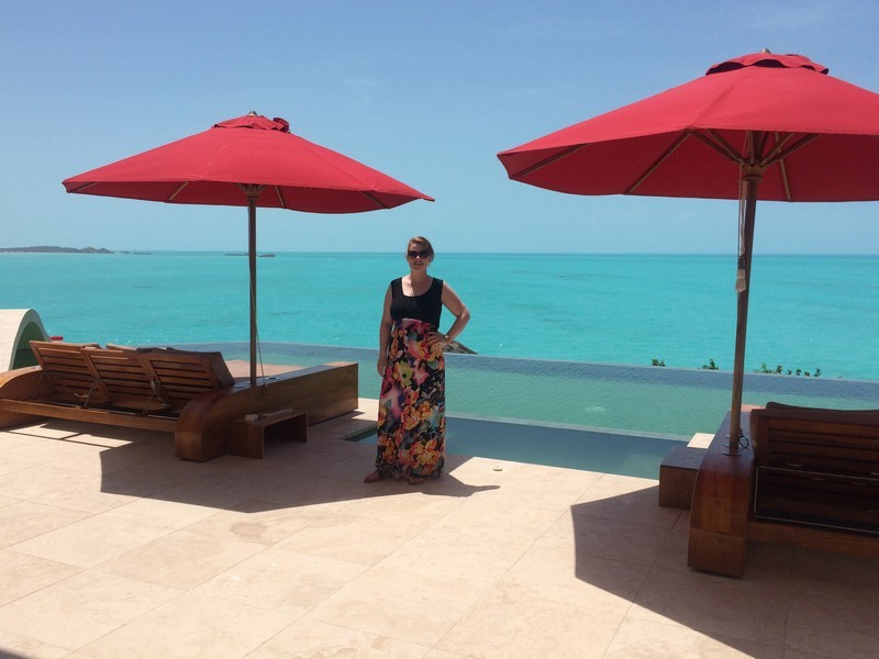 Linda standing by the pool at Balinese villa in Turks and Caicos