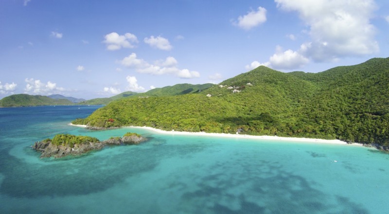 Aerial view of densly forested hills over-looking transparent blue waters in the US Virgin Islands