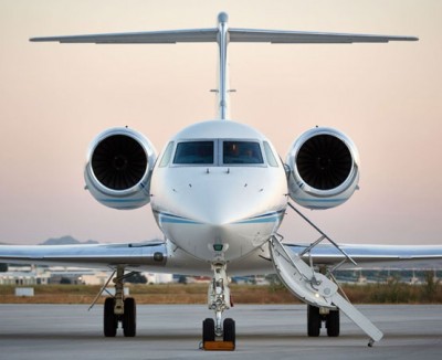 A regal wings executive jet sits patiently on a runway in the evening sun waiting to convey passengers in luxury to wherever they want to go