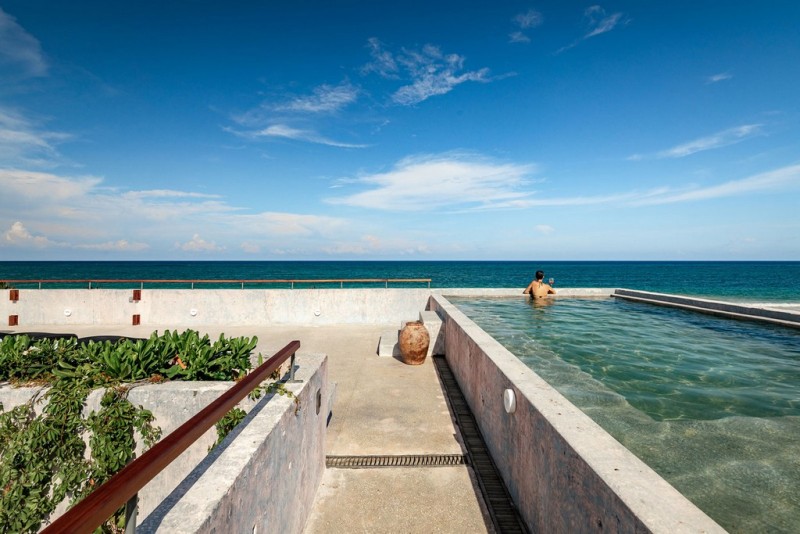 View of the rooftop pool and terrace with some greenery over