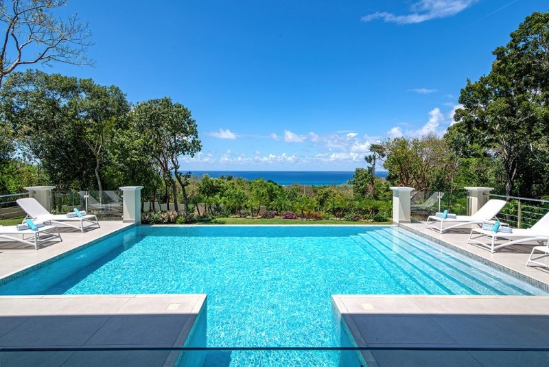 View of pool with sea in the background