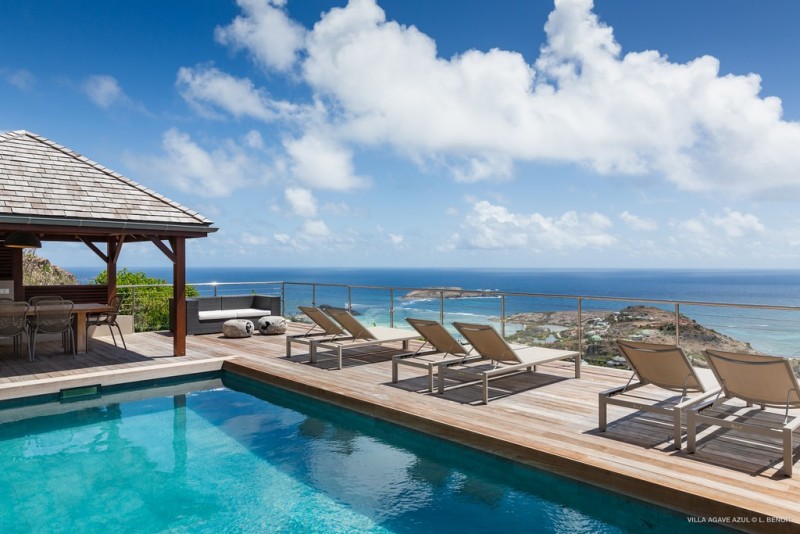 View of villa pool area with sea views in the background