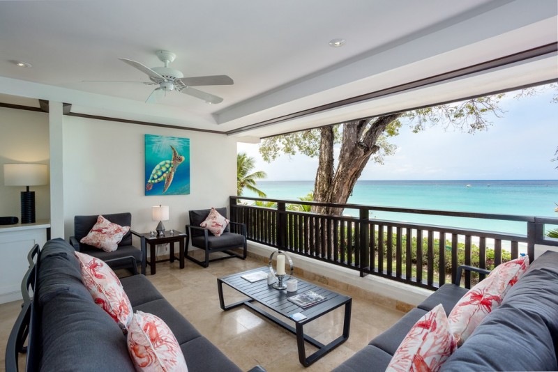 Outdoor sitting area and balcony with a view at Coral Cove 5